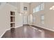 Spacious living room with tall ceilings, natural light, wood flooring, and open layout at 2864 Kinknockie Way, Henderson, NV 89044