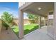 Covered patio offering a view of the backyard's artificial lawn, garden, and privacy wall at 2864 Kinknockie Way, Henderson, NV 89044