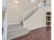 Bright foyer features a staircase with carpeted steps and an adjacent built-in shelving nook at 2864 Kinknockie Way, Henderson, NV 89044