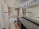 Bathroom with large vanity, granite countertops, and tiled shower/tub area at 2867 Geary Pl # 3008, Las Vegas, NV 89109