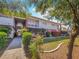 Condominium exterior with lush green landscaping and a concrete sidewalk leading to the building at 2867 Geary Pl # 3008, Las Vegas, NV 89109