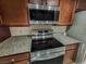 Updated kitchen features granite countertops and modern stainless-steel appliances at 2867 Geary Pl # 3008, Las Vegas, NV 89109