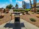 Community outdoor grill area featuring a stainless steel grill and manicured gravel landscaping at 2867 Geary Pl # 3008, Las Vegas, NV 89109