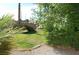 This home's backyard offers a lush lawn and mature foliage, perfect for outdoor activities at 30 Diamond Bar Rd, Pahrump, NV 89048