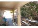 Relax on this home's covered patio, shaded by a tree in full bloom, with ample room for outdoor dining at 30 Diamond Bar Rd, Pahrump, NV 89048