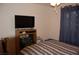 Bedroom with TV and striped bedding at 30 Diamond Bar Rd, Pahrump, NV 89048