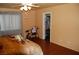 Relaxing bedroom with natural light, featuring wood-look flooring and a walk-in closet at 30 Diamond Bar Rd, Pahrump, NV 89048