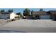 Spacious driveway leading to a two-car garage with an adjacent low-maintenance landscaped area at 30 Diamond Bar Rd, Pahrump, NV 89048