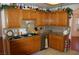 Charming kitchen featuring granite countertops, tile backsplash, and abundant oak cabinetry at 30 Diamond Bar Rd, Pahrump, NV 89048