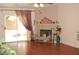 Inviting living room features a cozy fireplace, sliding glass door, and wood-look flooring at 30 Diamond Bar Rd, Pahrump, NV 89048