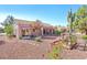 Charming backyard featuring desert landscaping, a covered patio, and a lush cactus at 3013 Sungold Dr, Las Vegas, NV 89134