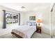 Well-lit bedroom with a cozy bed, window view, and a nightstand with a lamp at 3013 Sungold Dr, Las Vegas, NV 89134