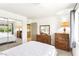 Bright bedroom with mirrored closet, dressers, lamp, and an open doorway to the hall and kitchen at 3013 Sungold Dr, Las Vegas, NV 89134