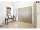 Tiled entryway with decorative mirror, lamps, console table, and double doors at 3013 Sungold Dr, Las Vegas, NV 89134