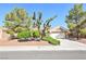 Charming home featuring desert landscaping and a two-car garage at 3013 Sungold Dr, Las Vegas, NV 89134