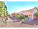 A vibrant home with desert landscaping, mature cactus, and a tiled roof at 3013 Sungold Dr, Las Vegas, NV 89134