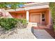 Inviting front entrance featuring a tile walkway and mature landscaping at 3013 Sungold Dr, Las Vegas, NV 89134