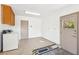 Clean garage space with washer, overhead cabinets, utility sink, and access door at 3013 Sungold Dr, Las Vegas, NV 89134