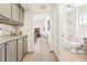 A hallway features built in cabinets and connects the dining area with the bathroom at 3013 Sungold Dr, Las Vegas, NV 89134