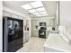 Traditional kitchen with stainless steel appliances, tile floors, neutral cabinets, and bright lighting at 3013 Sungold Dr, Las Vegas, NV 89134