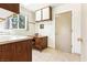 Bright kitchen featuring a small desk nook, white cabinets, and a window that brings in natural light at 3013 Sungold Dr, Las Vegas, NV 89134