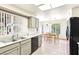 Open kitchen featuring neutral tones, black appliances, and an adjacent dining area at 3013 Sungold Dr, Las Vegas, NV 89134