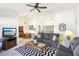 Spacious living room with neutral walls, ceiling fan, and dining area adjacent at 3013 Sungold Dr, Las Vegas, NV 89134