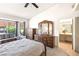 Bright main bedroom with a window view, a nice bed, and an ensuite bathroom at 3013 Sungold Dr, Las Vegas, NV 89134