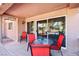 Covered patio with red chairs and a table, perfect for outdoor dining and relaxation at 3013 Sungold Dr, Las Vegas, NV 89134