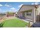 Backyard featuring artificial turf, desert landscaping, a brick pathway, a pergola, and mountain views at 3096 Beaux Art Ave, Henderson, NV 89044
