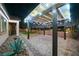 A gorgeous brick patio area with a pergola, lights, and desert landscaping is perfect for entertaining at 3096 Beaux Art Ave, Henderson, NV 89044