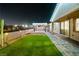 A backyard with a lush green lawn, brick patio, and desert landscaping, great for outdoor living at 3096 Beaux Art Ave, Henderson, NV 89044