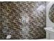 Powder room with designer glass backsplash behind a pedestal sink and toilet at 3096 Beaux Art Ave, Henderson, NV 89044