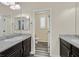 Bathroom featuring granite countertops, dark cabinets, and dual sinks with black and white striped floors leading to toilet at 3096 Beaux Art Ave, Henderson, NV 89044