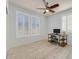 Bright bedroom with shuttered windows, light hardwood flooring, ceiling fan, and a desk for work or study at 3096 Beaux Art Ave, Henderson, NV 89044