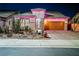 A cozy single-Gathering home with desert landscaping, two-car garage, brick driveway and purple lights at 3096 Beaux Art Ave, Henderson, NV 89044