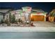 Single-Gathering home with brick driveway, desert landscaping, and holiday lights, located in a suburban area at 3096 Beaux Art Ave, Henderson, NV 89044