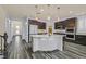 Open kitchen with a large center island, stainless steel appliances, and a breakfast bar at 3096 Beaux Art Ave, Henderson, NV 89044