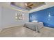 Main bedroom with accent wall, ceiling fan and lighting, and wood-look flooring at 3096 Beaux Art Ave, Henderson, NV 89044