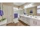 Bright bathroom with dual sinks, white cabinets, and a shower-tub combo featuring modern fixtures at 344 Golden Shore Dr, Las Vegas, NV 89123
