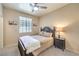Comfortable bedroom with soft lighting, plush bedding, a ceiling fan, and neutral wall color at 344 Golden Shore Dr, Las Vegas, NV 89123