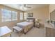 Inviting bedroom with natural light, ceiling fan, neutral decor, and comfortable furnishings at 344 Golden Shore Dr, Las Vegas, NV 89123