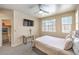 Relaxing bedroom with a mounted TV, plush bedding, and a well-organized walk-in closet at 344 Golden Shore Dr, Las Vegas, NV 89123