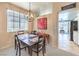 Cozy dining area with modern chandelier, seating for six, and view to the living room and kitchen at 344 Golden Shore Dr, Las Vegas, NV 89123