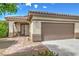 Attractive single-story home with a two-car garage, inviting walkway, and desert landscaping at 344 Golden Shore Dr, Las Vegas, NV 89123