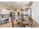Bright kitchen area with white cabinets, stainless steel appliances, and a dining table with chairs at 344 Golden Shore Dr, Las Vegas, NV 89123