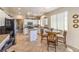 Bright kitchen with white cabinets, stainless steel appliances, and a dining table with chairs at 344 Golden Shore Dr, Las Vegas, NV 89123