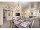Inviting living area with modern chandelier, dining table, and comfortable gray sofa at 344 Golden Shore Dr, Las Vegas, NV 89123