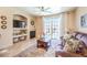 Cozy living room with tile floors, a fireplace, and sliding glass doors to the outdoor pool at 344 Golden Shore Dr, Las Vegas, NV 89123