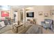 Open-concept living area with a dining space, comfortable seating, and stylish modern decor at 344 Golden Shore Dr, Las Vegas, NV 89123